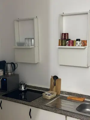 a kitchen with a sink and a counter top at Les Paniers de MARRAKECH 1 in Marrakech