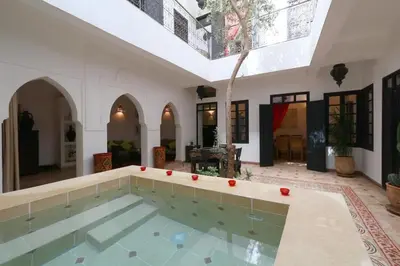 an indoor pool in a house with a large room at Riad XCIX, basin, 3 bedrooms in Medina excluded in Marrakech