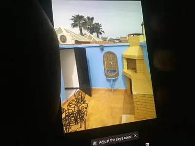 a tv screen with a picture of a building at Marrakech village touristique in Marrakech