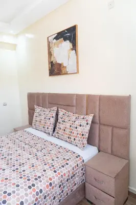 a bedroom with a bed and a picture on the wall at Appartement de luxe, à 2min de Guéliz in Marrakech