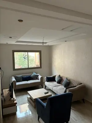 a living room with two couches and a table at Gemütliche Wohnung in Marakesch in Marrakech