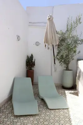 two white chairs in a room with potted plants at DeaRiad, Medina, Basin, 2 Bedrooms in Marrakech