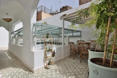 a patio with potted plants and a table at DeaRiad, Medina, Basin, 2 Bedrooms in Marrakech