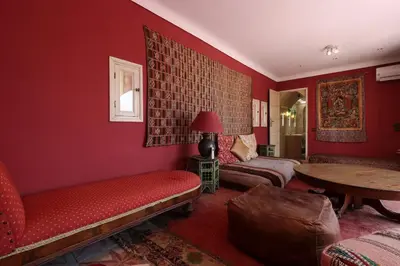 a red living room with a couch and a table at Riad La Tulipe, private, 4 Ch, medina in Marrakech