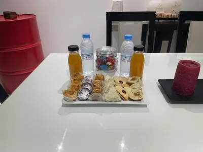 a table with a tray of donuts and bottles of water at 3 bedroom villa with private pool near centre in Marrakech