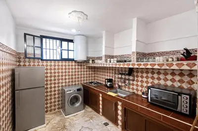 a kitchen with a refrigerator and a microwave at 2 bedroom apartment in heart of Madina in Marrakech