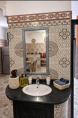 a bathroom with a sink and a mirror at 2 bedroom apartment in heart of Madina in Marrakech