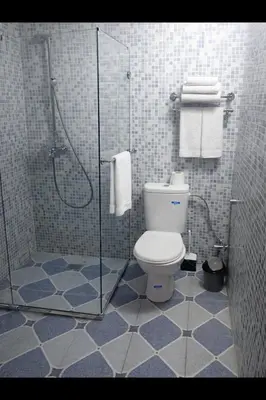 a bathroom with a toilet and a glass shower at 2 bedroom apartment in heart of Madina in Marrakech