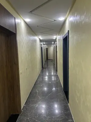 an empty hallway with a tile floor in a building at malak g7 in Marrakech