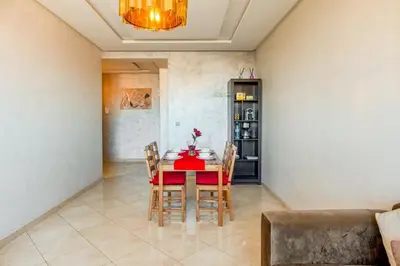 a dining room with a red table and chairs at Logement entier Appartement Cosy - Marrakech in Marrakech