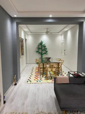 a living room with a dining room table and a table and a dining room at Appartement luxe in Marrakech