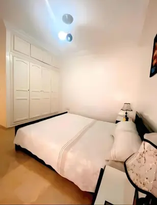 a bedroom with a large white bed with two pillows at سكن امن وهادى in Marrakech