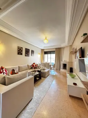 a living room with a couch and a table at Marrakech Oasis, Residence Ennaim in Marrakech