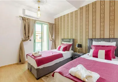 a bedroom with two beds and a window at Charming Two-Bedroom Apartment in Gueliz,Marrakesh in Marrakech