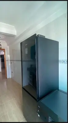 a large black refrigerator sitting in a room at Charming Two-Bedroom Apartment in Gueliz,Marrakesh in Marrakech