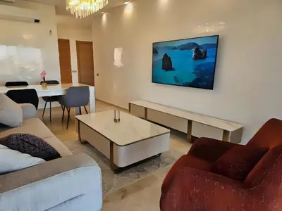 a living room with a couch and a table at Prestigia Luxury Golf-View Escape in Marrakech