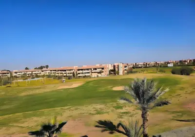 an overhead view of a golf course with palm trees at Prestigia Luxury Golf-View Escape in Marrakech