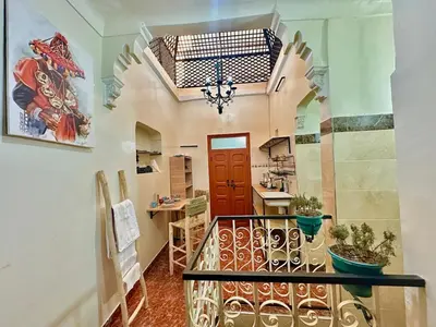 a hallway with a staircase with a red door at Dar Safary in Marrakech