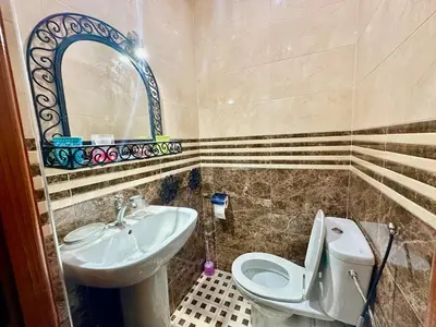 a bathroom with a sink and a toilet and a mirror at Dar Safary in Marrakech
