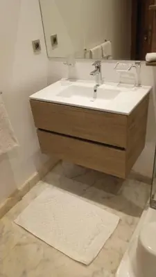 a bathroom with a sink and a mirror at villa du golf in Marrakech