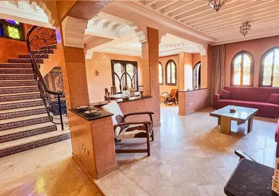 a living room with a staircase and a red couch at Charming townhouse in Marrakech in Marrakech