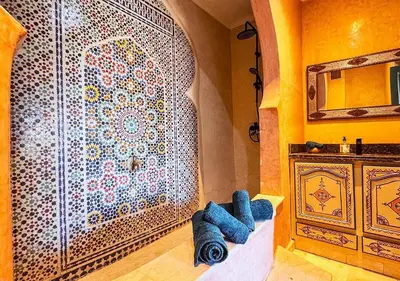a room with a large wall with a mosaic wall at Charming townhouse in Marrakech in Marrakech