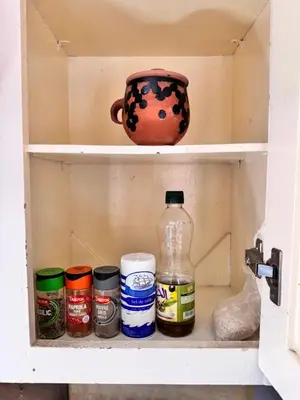 a drawer of a cabinet with jars and a vase at Charming townhouse in Marrakech in Marrakech