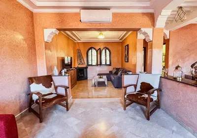 a living room with two chairs and a couch at Charming townhouse in Marrakech in Marrakech