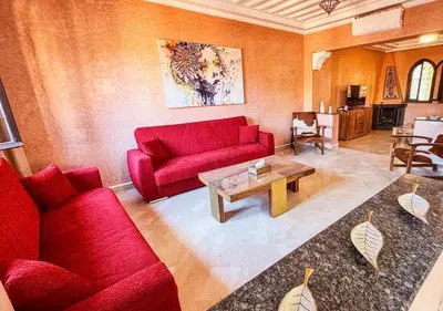 a living room with red couches and a coffee table at Charming townhouse in Marrakech in Marrakech