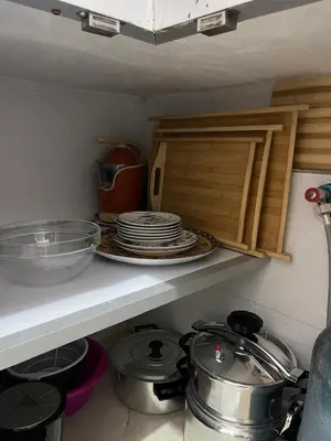 a kitchen counter with plates and dishes on a shelf at Apartment in Marrakesh in Marrakech