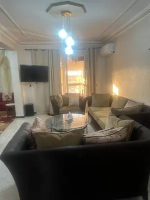 a living room with a couch and a glass table at Appartement Layane 2 chambres 8 mn de gueliz in Marrakech