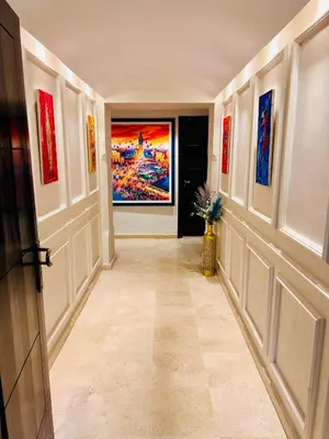 a hallway with paintings on the walls at Résidence Miramas Gueliz in Marrakech