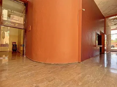 an empty hallway of a building with an orange wall at Cosy and spacious apartment in Gueliz in Marrakech