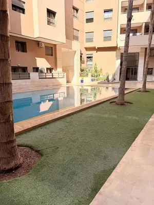 a courtyard with a swimming pool in a building at Appartement au cœur de Marrakech in Marrakech