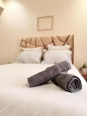 a rolled up towel sitting on a bed at Appartement au cœur de Marrakech in Marrakech