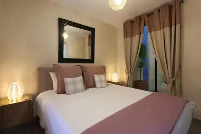 a bedroom with a large white bed with a mirror at Souffle d 'Orient, easy access to medina & basin in Marrakech