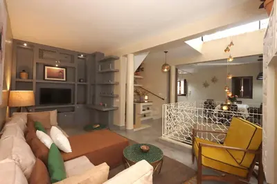 a living room with a couch and a table at Souffle d 'Orient, easy access to medina & basin in Marrakech