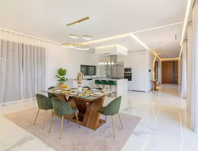 a kitchen and dining room with a table and chairs at Villa Elysée - Piscine et jardin Privée Sans vis-à-vis Wifi HD in Sraghna