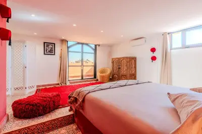 a bedroom with a large bed and a window at Villa d Exception 5 suites et piscine privee in Marrakech