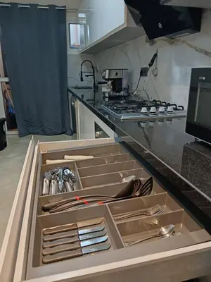 a kitchen with an open drawer with utensils at Apartement Gueliz Marrakech in Marrakech