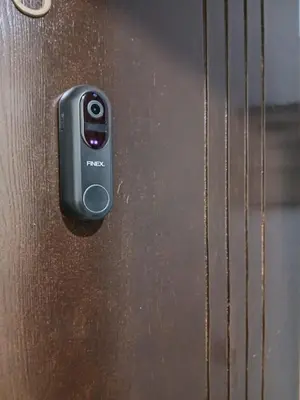 a black remote control on a wooden door at Apartement Gueliz Marrakech in Marrakech