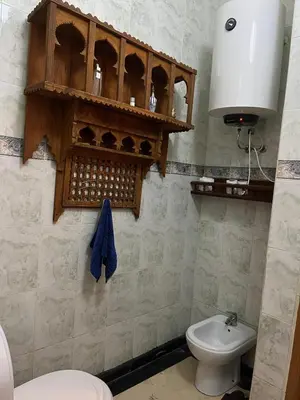 a bathroom with a toilet and a sink at Family residence with a pool in Marrakech