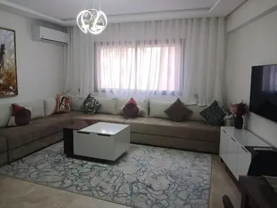 a living room with a couch and a tv at marrakech semlalia gueliz in Marrakech