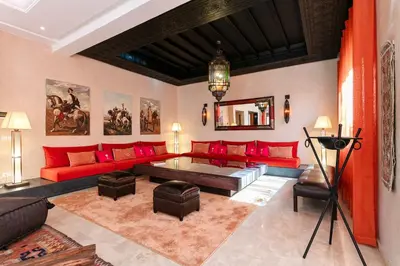 a living room with red couches and a table at Amelkis Golf Marrakech, Villa 6ch, piscine chauffée in Marrakech