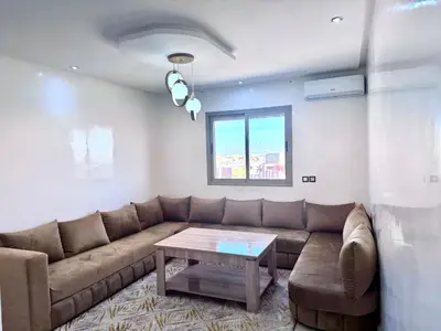 a living room with a couch and a table at RENTSUITE SPACIOUS and COMFY 2 BEDROOM in Marrakech