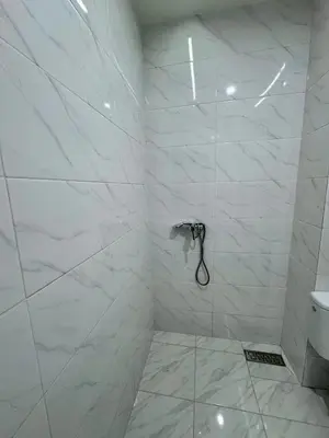 a bathroom with a shower with white marble walls at RENTSUITE SPACIOUS and COMFY 2 BEDROOM in Marrakech