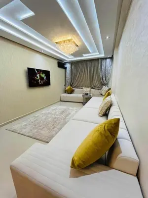 a bedroom with two beds with a yellow pillow on it at Apartment au cœur de Marrakesh in Marrakech