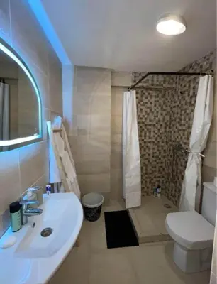a bathroom with a sink and a shower and a toilet at Apartment au cœur de Marrakesh in Marrakech