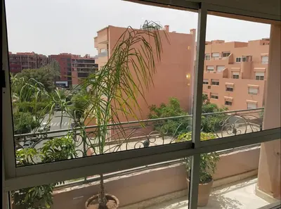 a window view of a balcony with a palm tree at Urban Chic 2 bedrooms in Utimate City Center in Marrakech