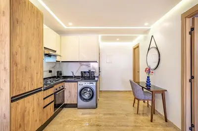 a kitchen with a washing machine and a table at New 1BR appt in gueliz in Marrakech
